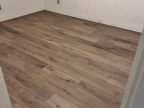 Plank flooring laid through a room