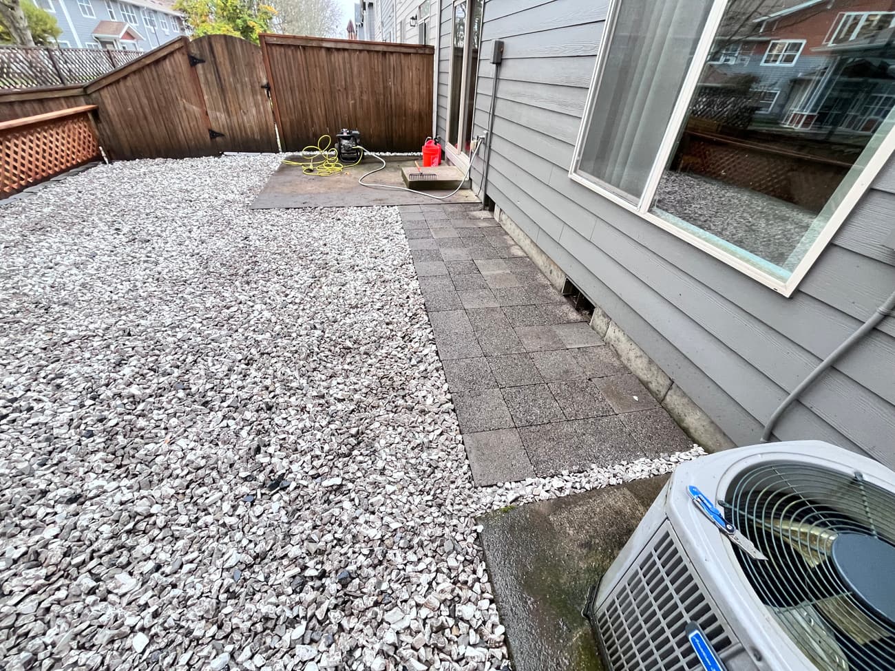 Paver path running down the side of the house past the exterior unit, with gravel either side